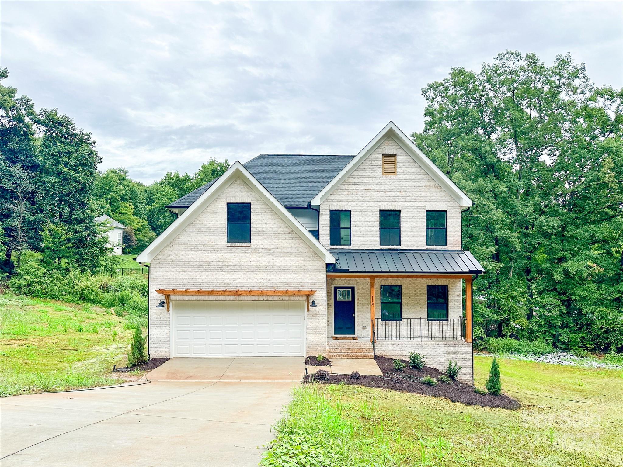 a front view of house with yard and green space