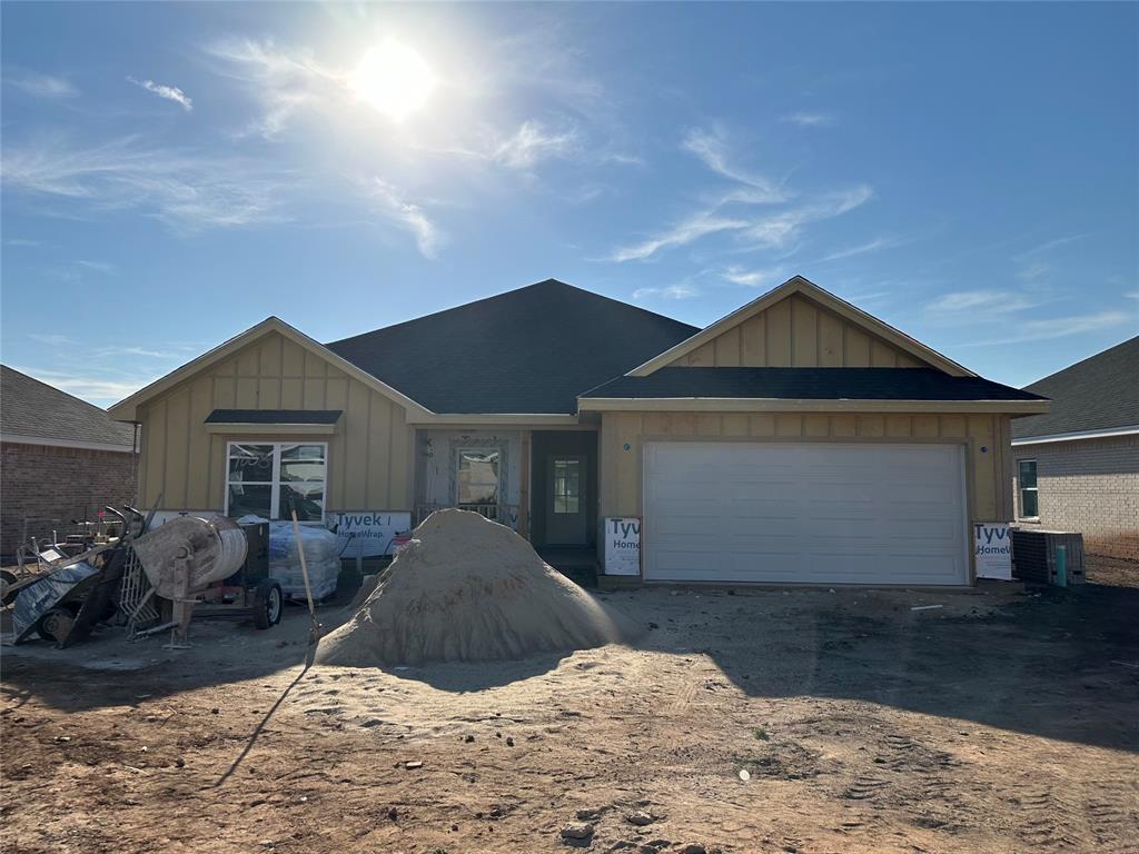 a view of a house with a yard and garage