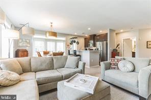 a view of living room kitchen with furniture and a large window