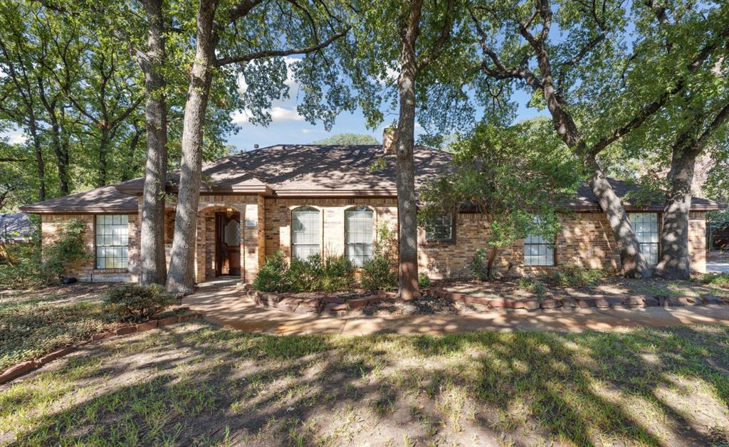 a view of a house with a tree in the yard