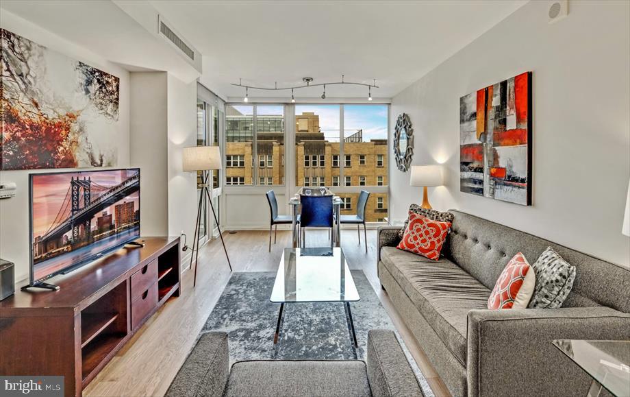 a living room with furniture and a book shelf