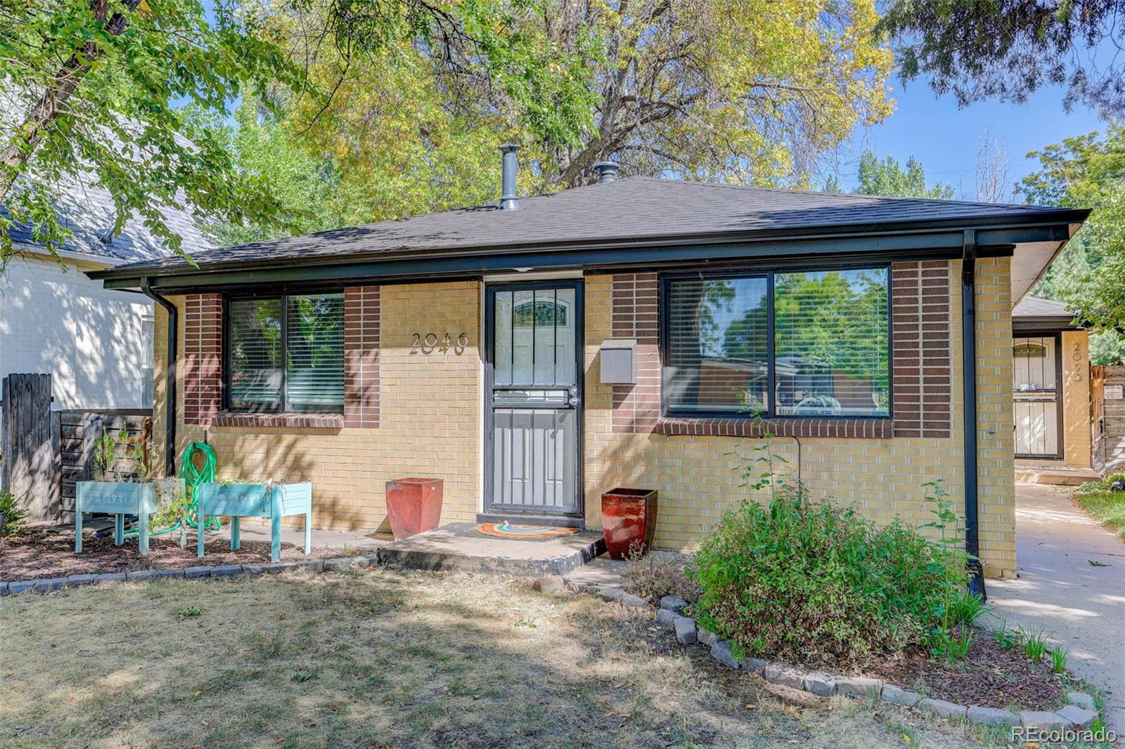 a view of a house with a backyard and a tree