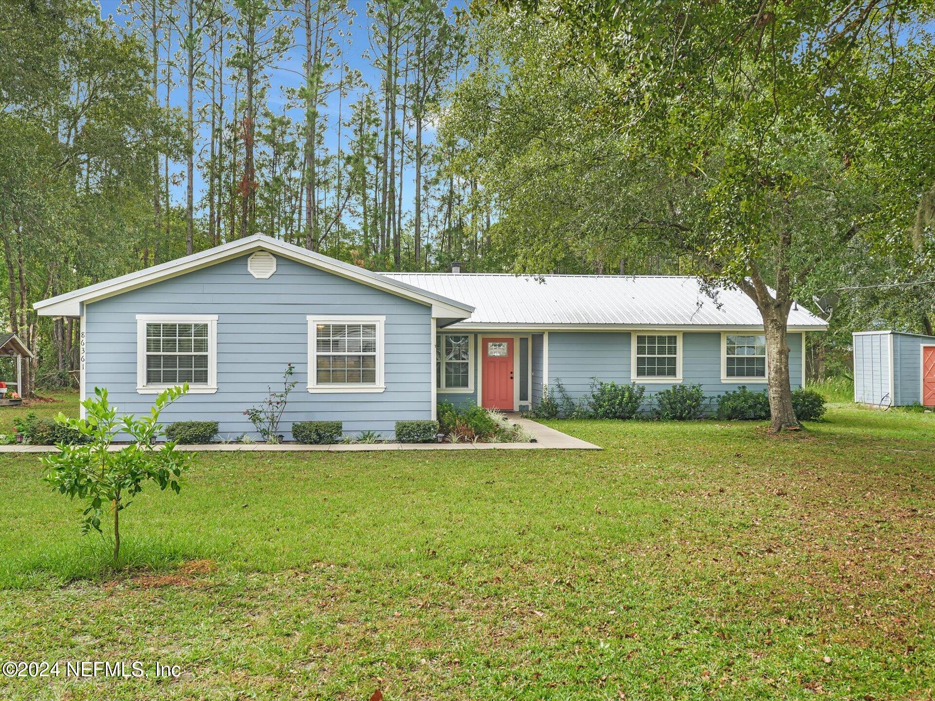 a front view of house with yard and green space