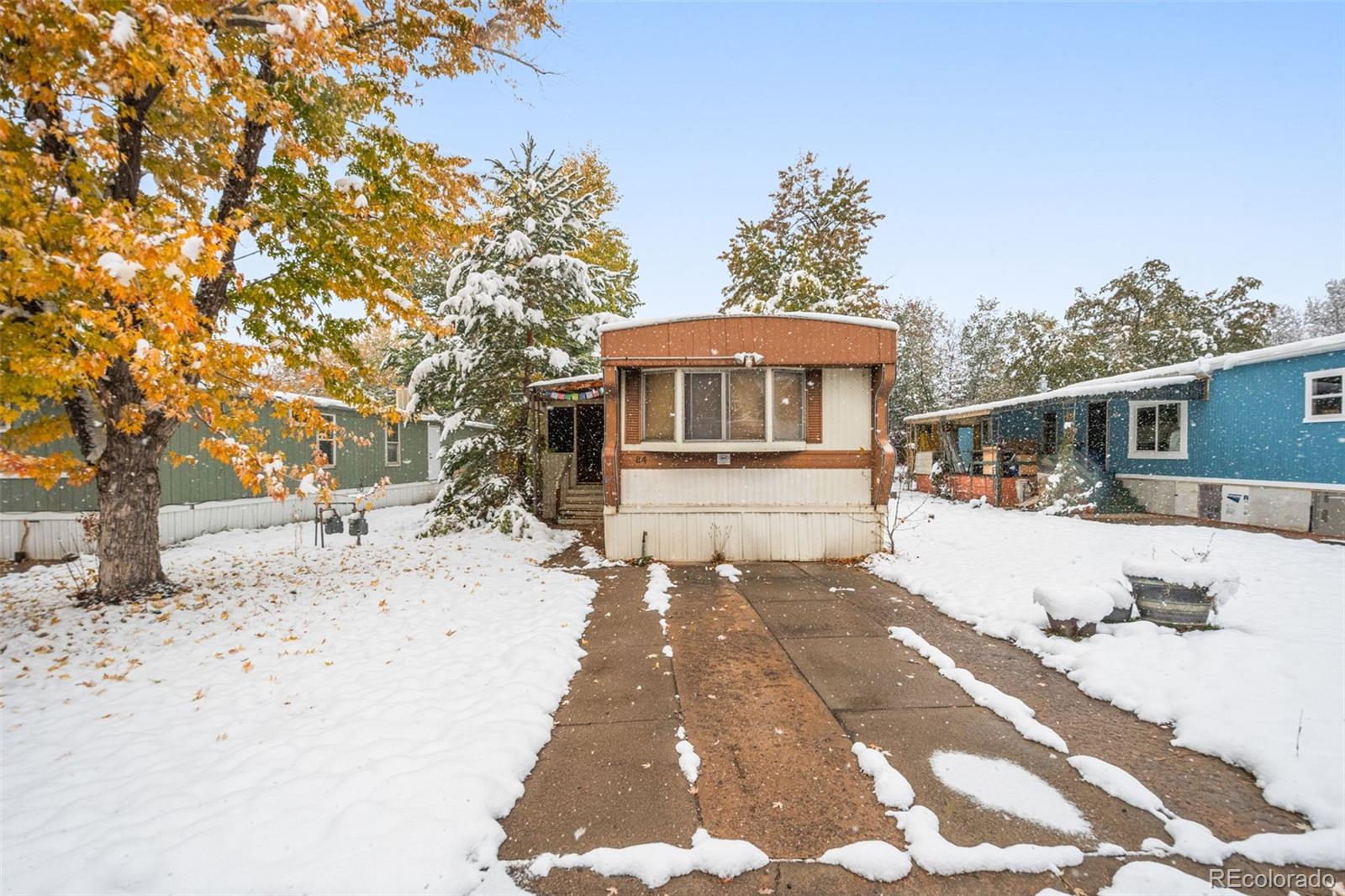 a view of a house with snow on the road