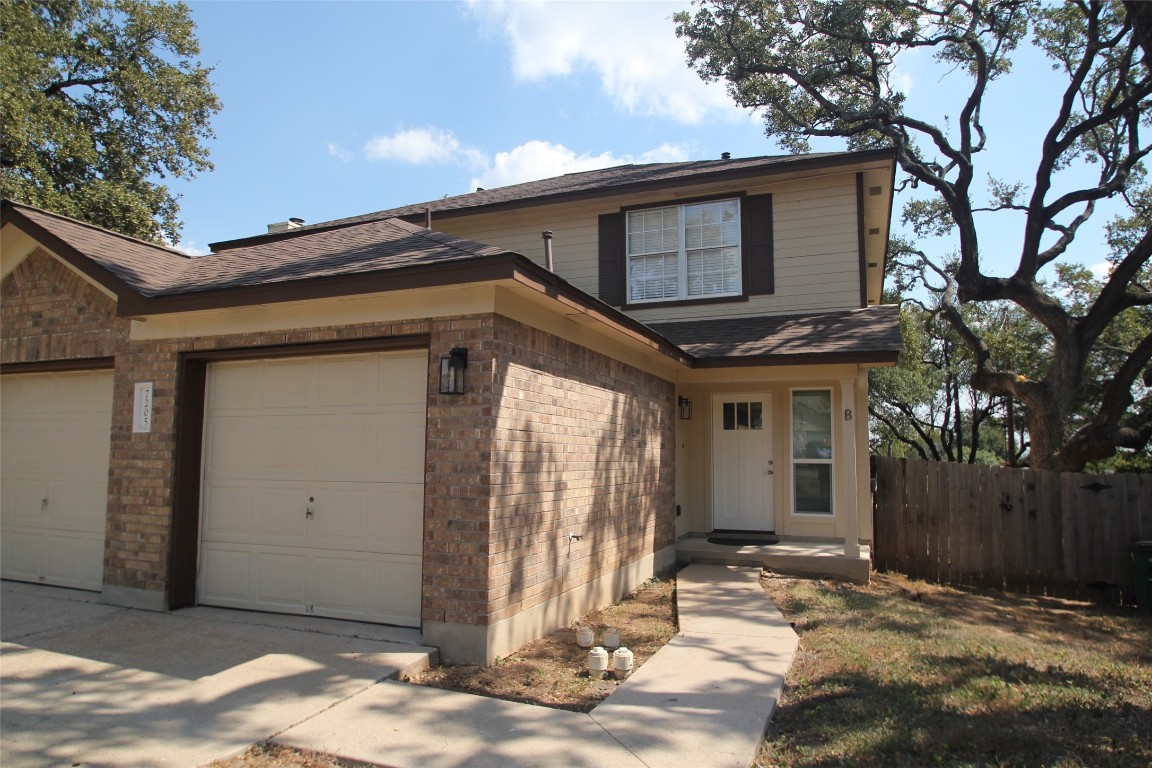 a view of a house with a small yard