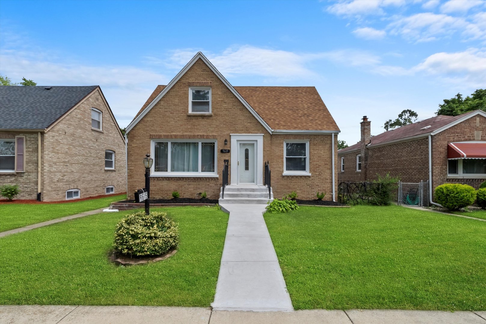 a front view of a house with a garden