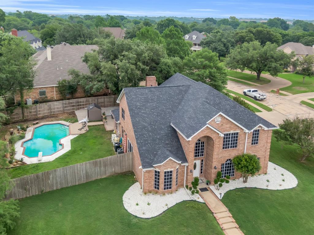 an aerial view of a house with a yard