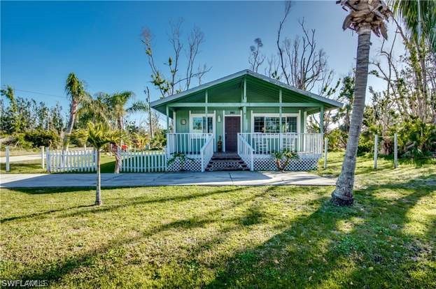 a view of a house with swimming pool and porch