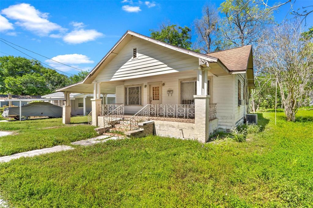 a view of a house with a yard and sitting area