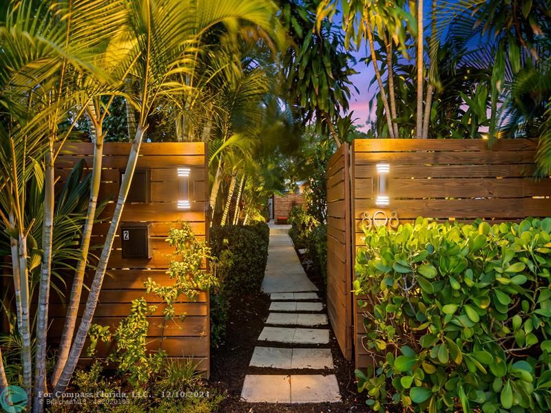 a view of a pathway of a house with a yard