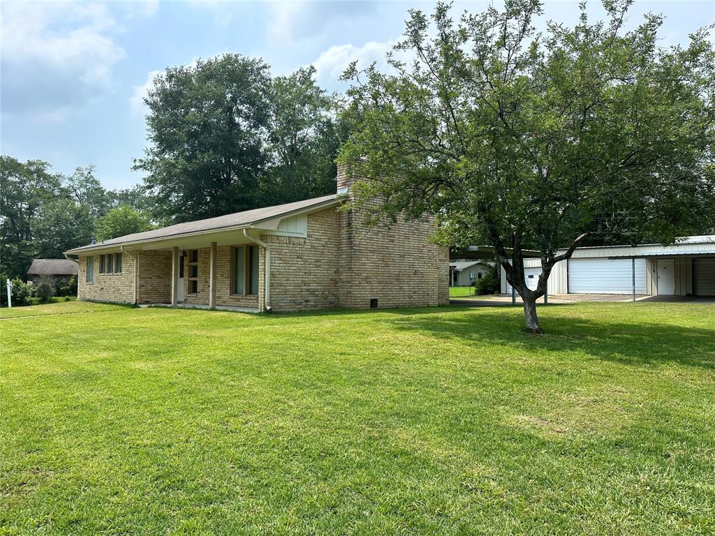 a front view of house with a garden