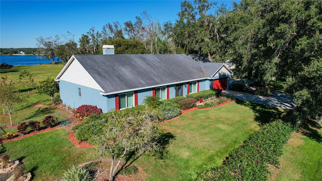 a aerial view of a house with yard and green space