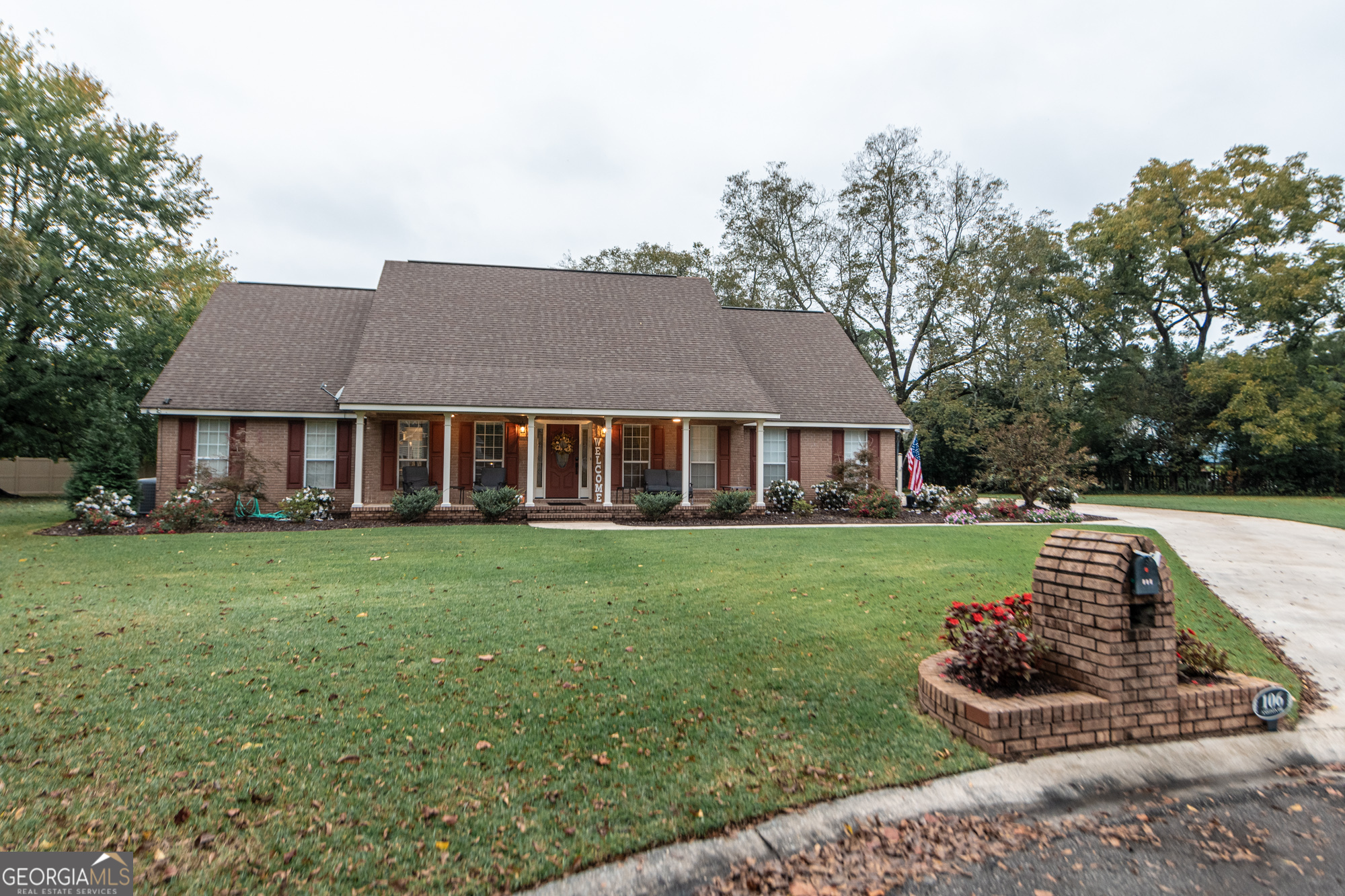 a front view of a house with a garden