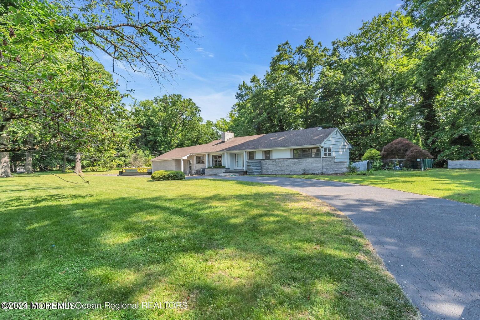 a front view of house with yard and green space