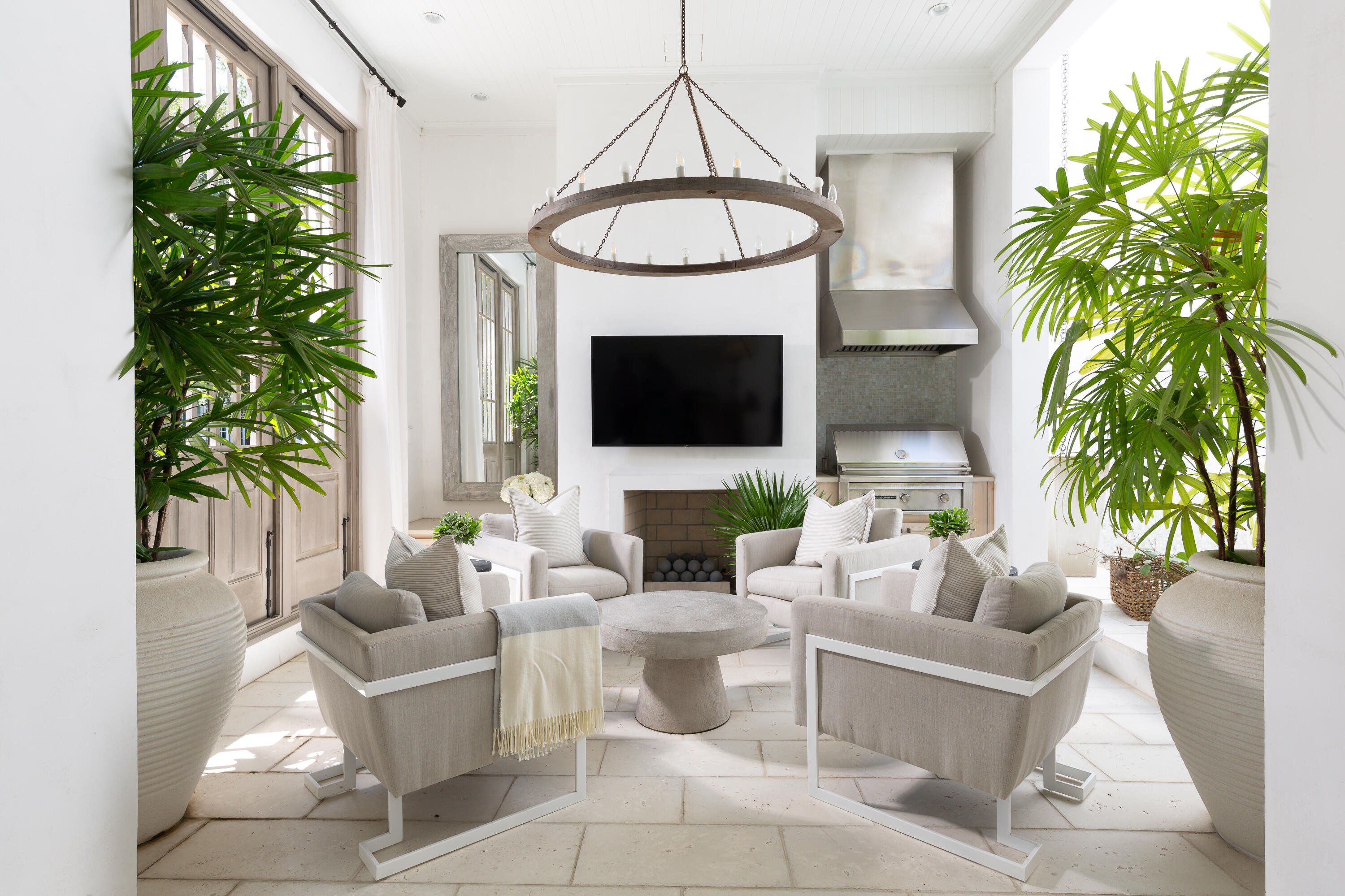 a living room with furniture a potted plant and a fireplace