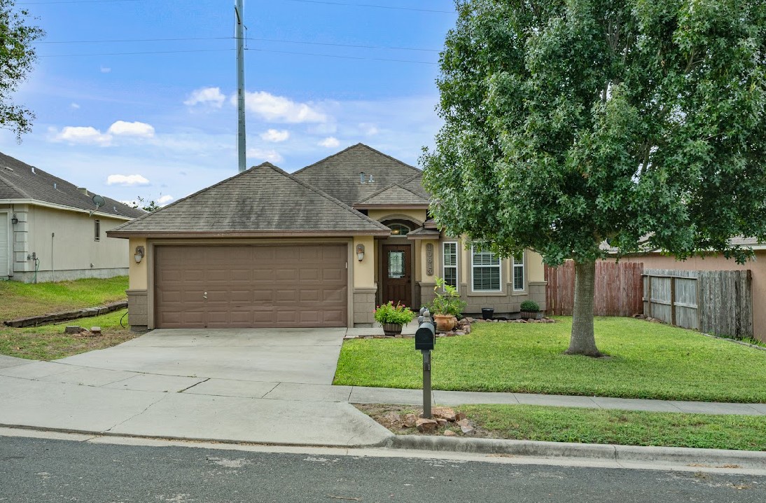 a front view of a house with a yard and garage