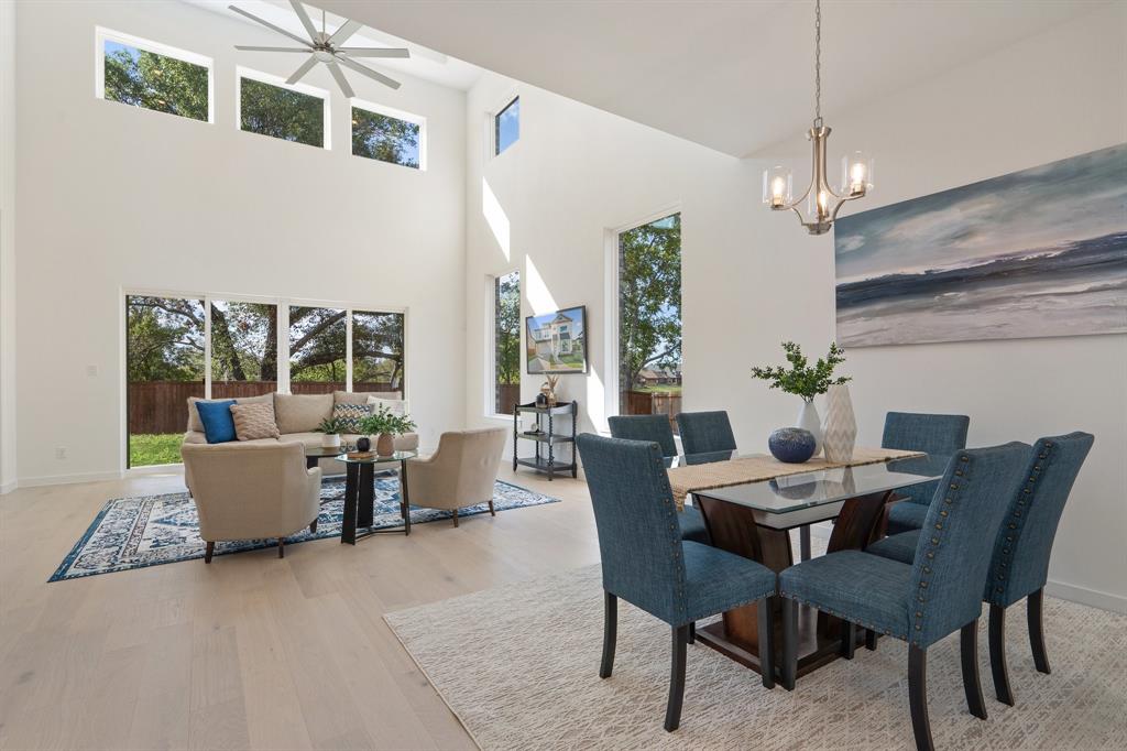 a view of a dining room with furniture and chandelier