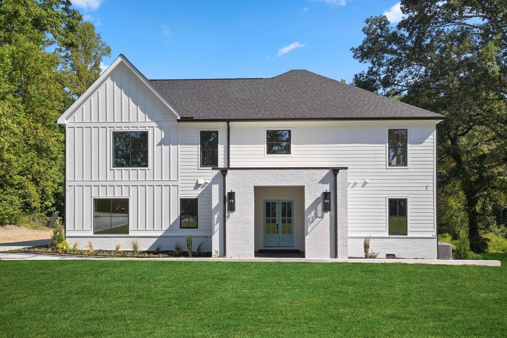 a front view of a house with a yard and porch