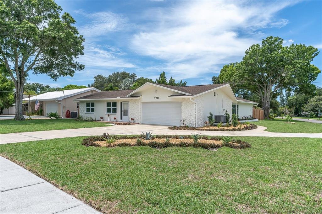 a front view of house with yard and green space