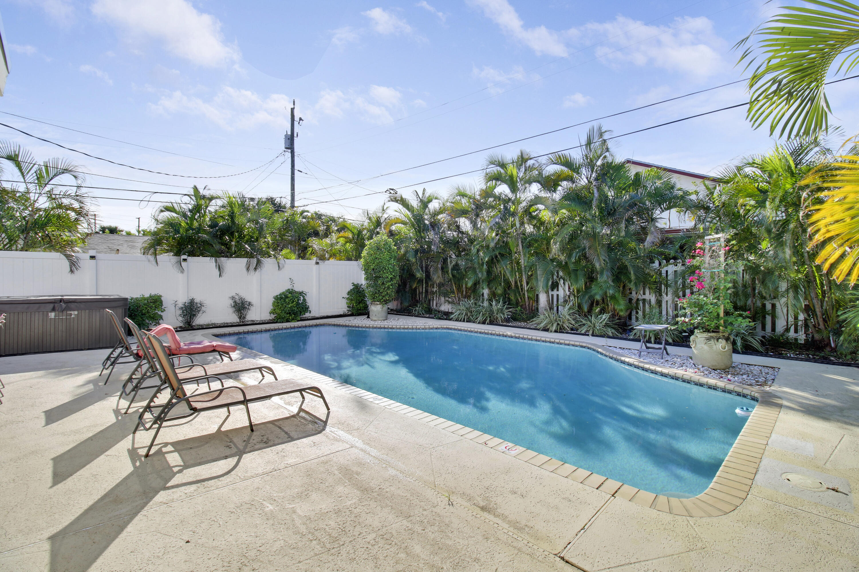 a view of swimming pool with outdoor seating and plants