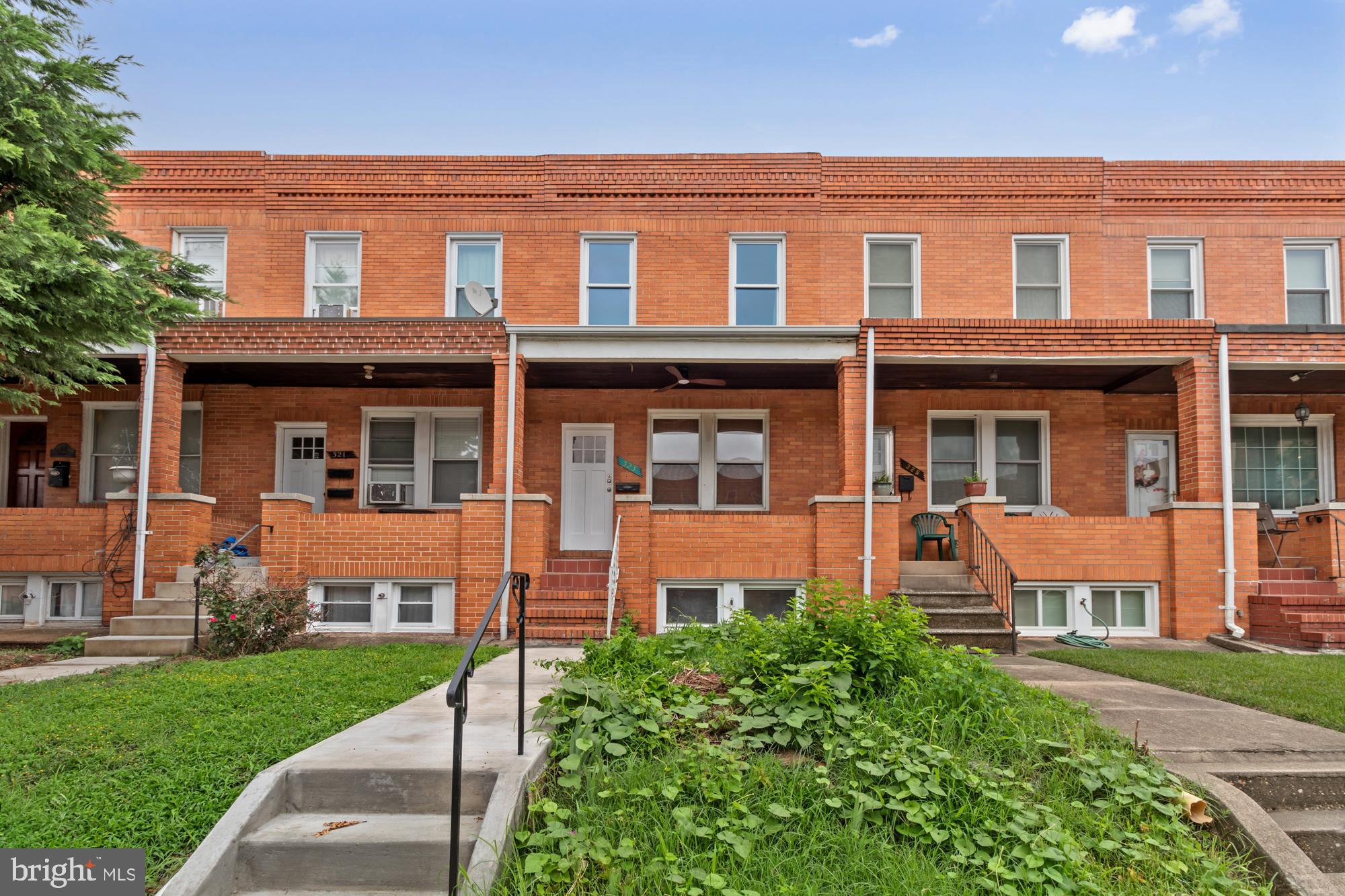 front view of a brick house with a yard