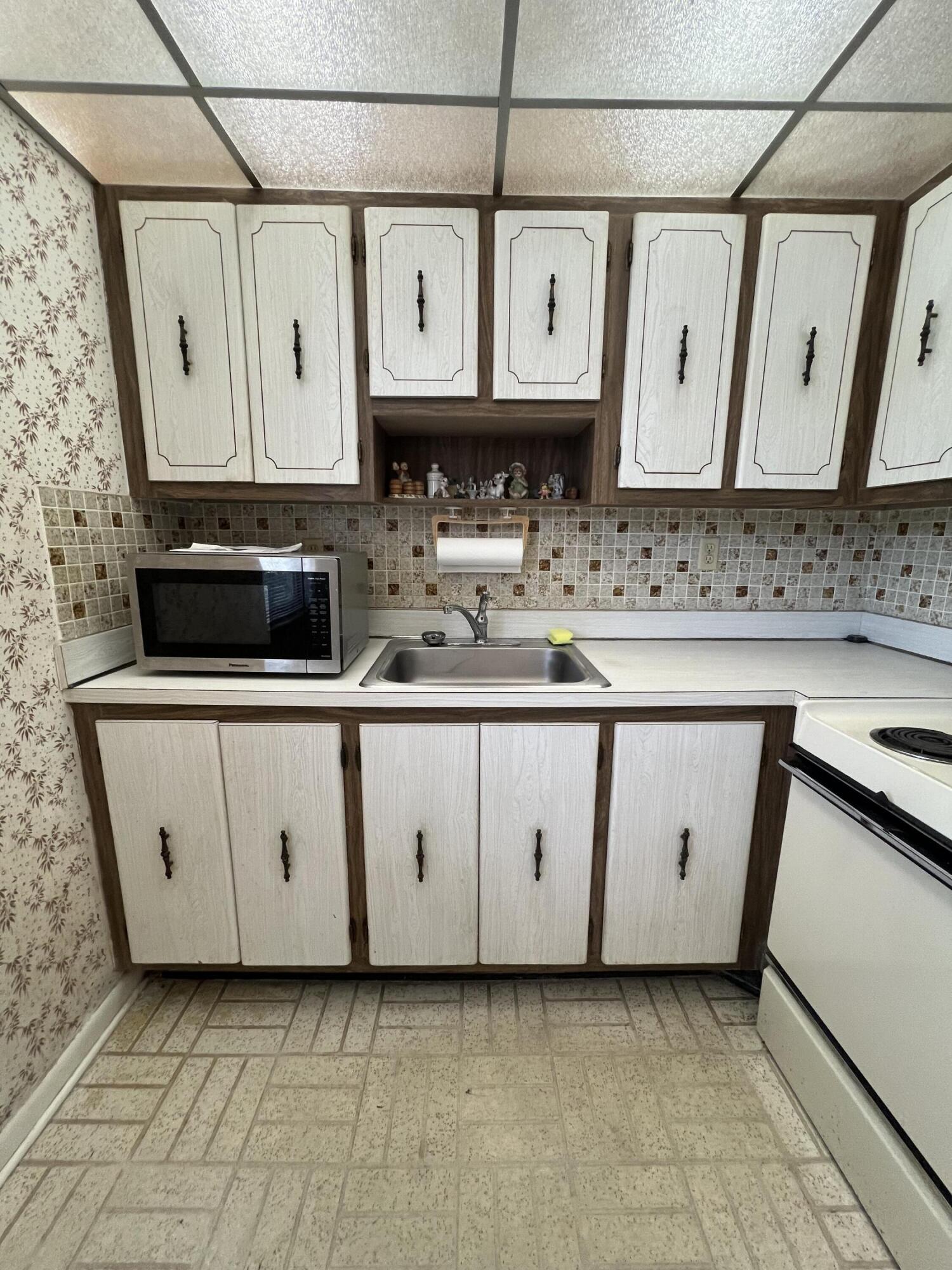 a kitchen with stainless steel appliances granite countertop a sink and a stove