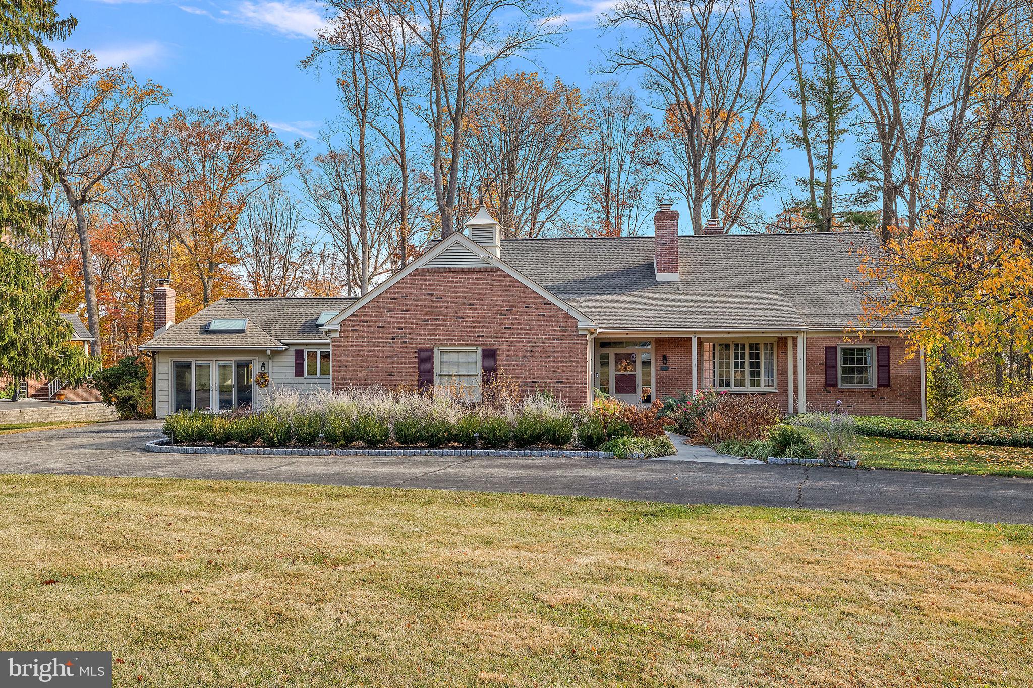 a front view of a house with a yard and lake view