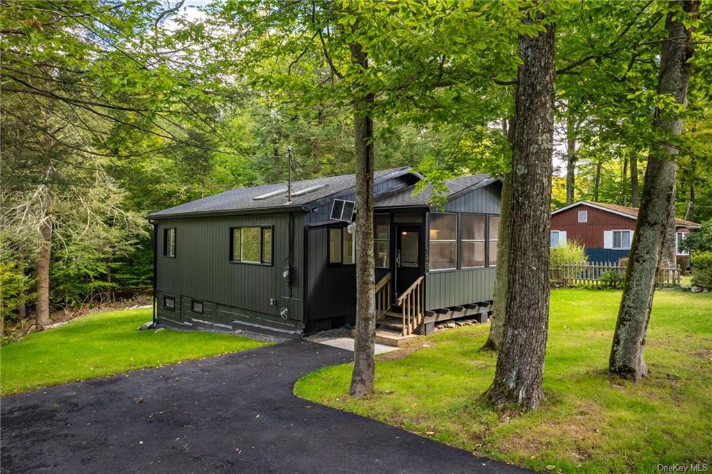 a view of a house with backyard and trees