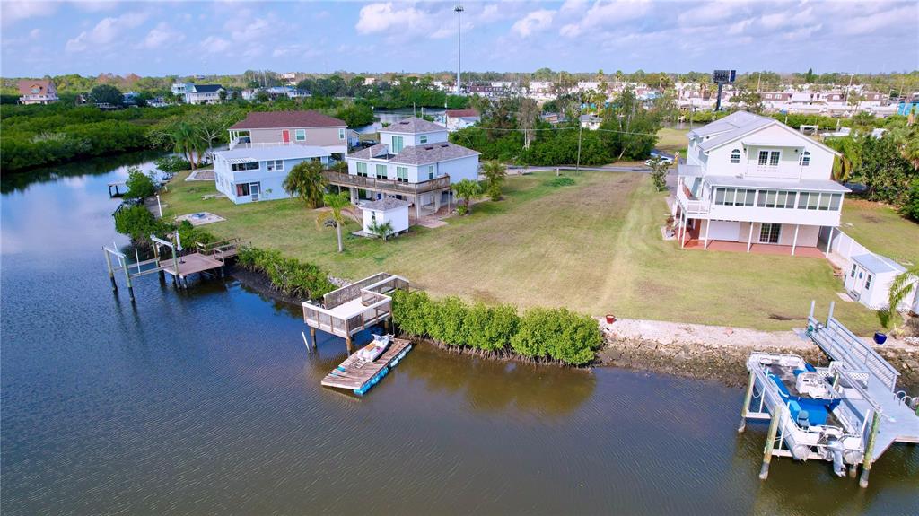 an aerial view of a house with a garden and lake view