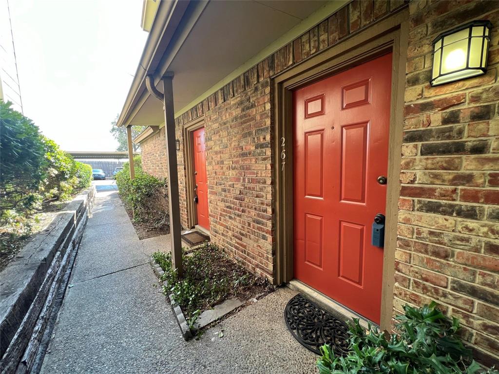 a view of a door and chair front of house