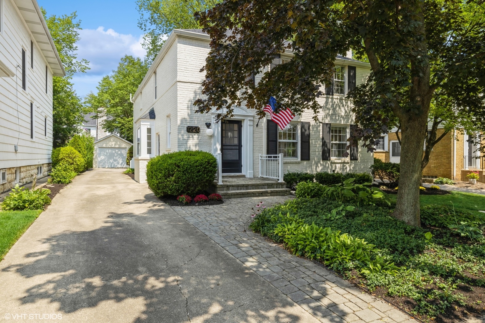 a front view of a house with a garden