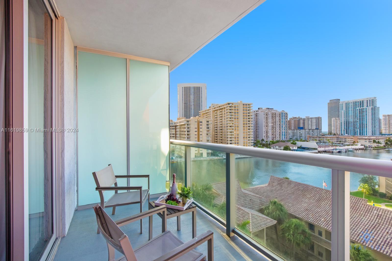 a balcony with a table and chairs