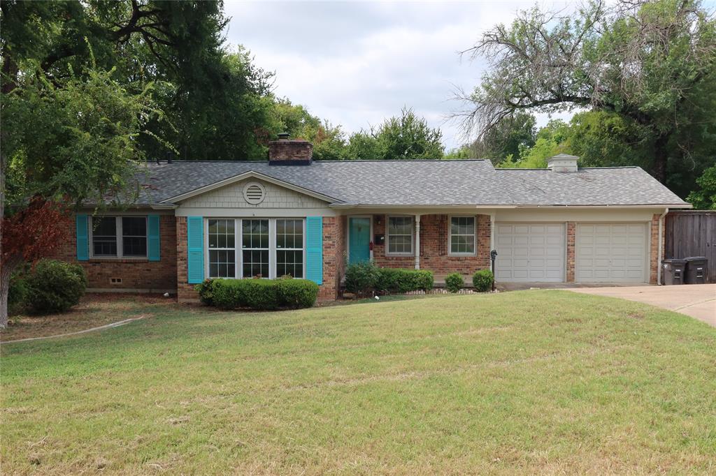 a front view of a house with a garden and yard