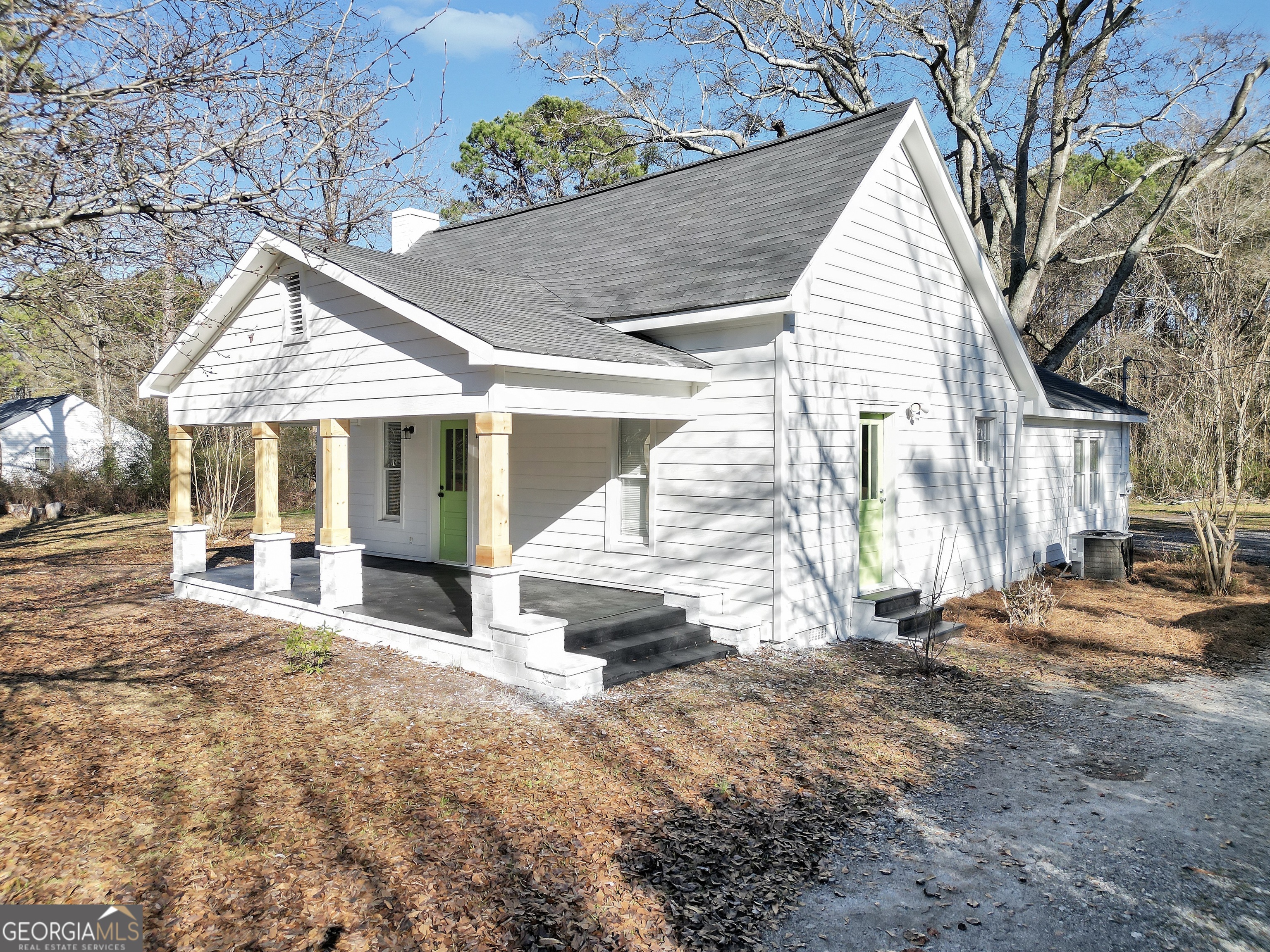 a view of a house with a yard and sitting area