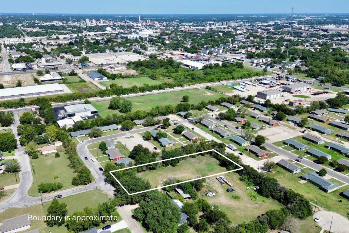 an aerial view of residential houses with outdoor space