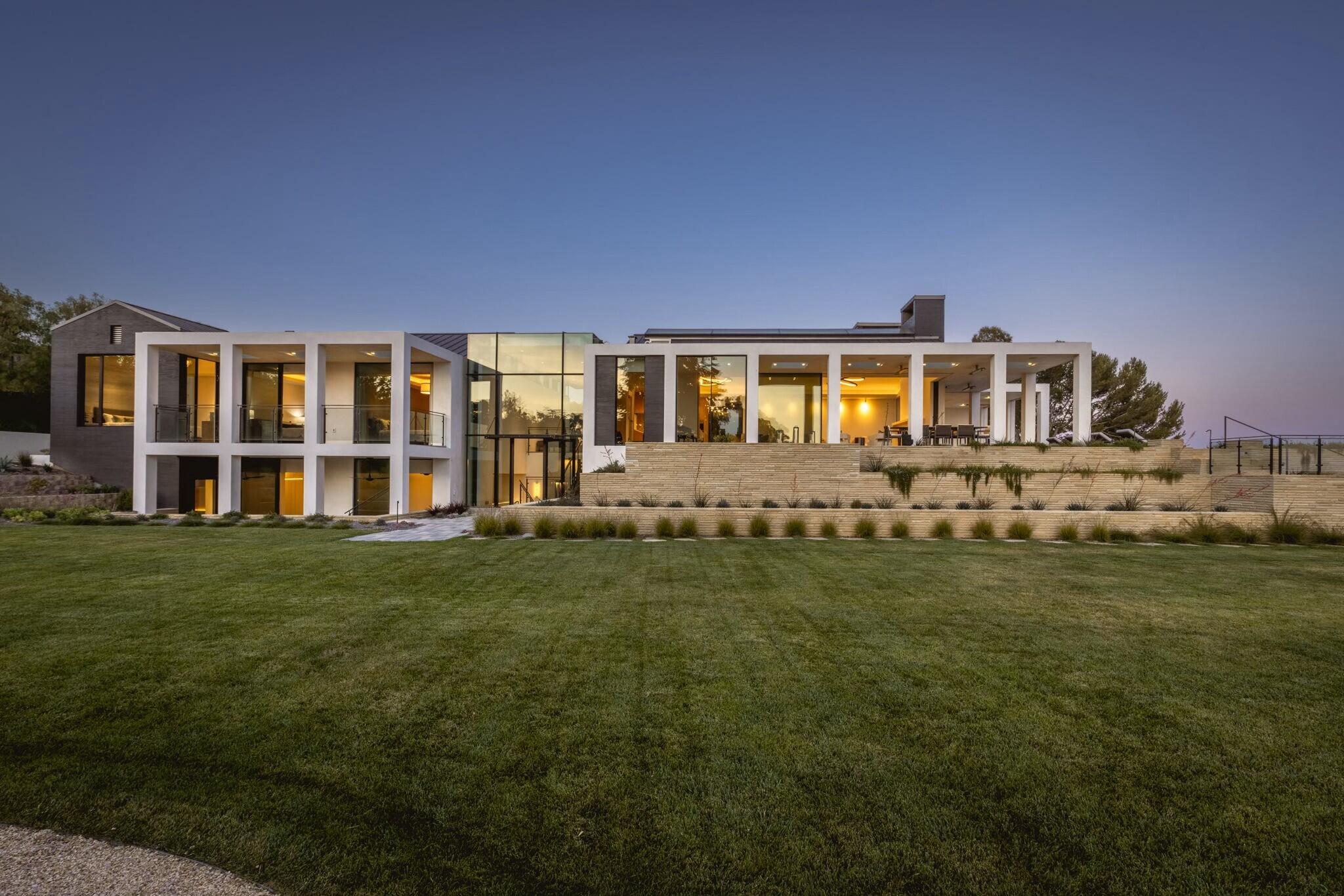 a front view of a house with a garden