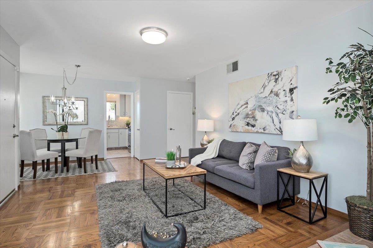 a living room with furniture and a chandelier