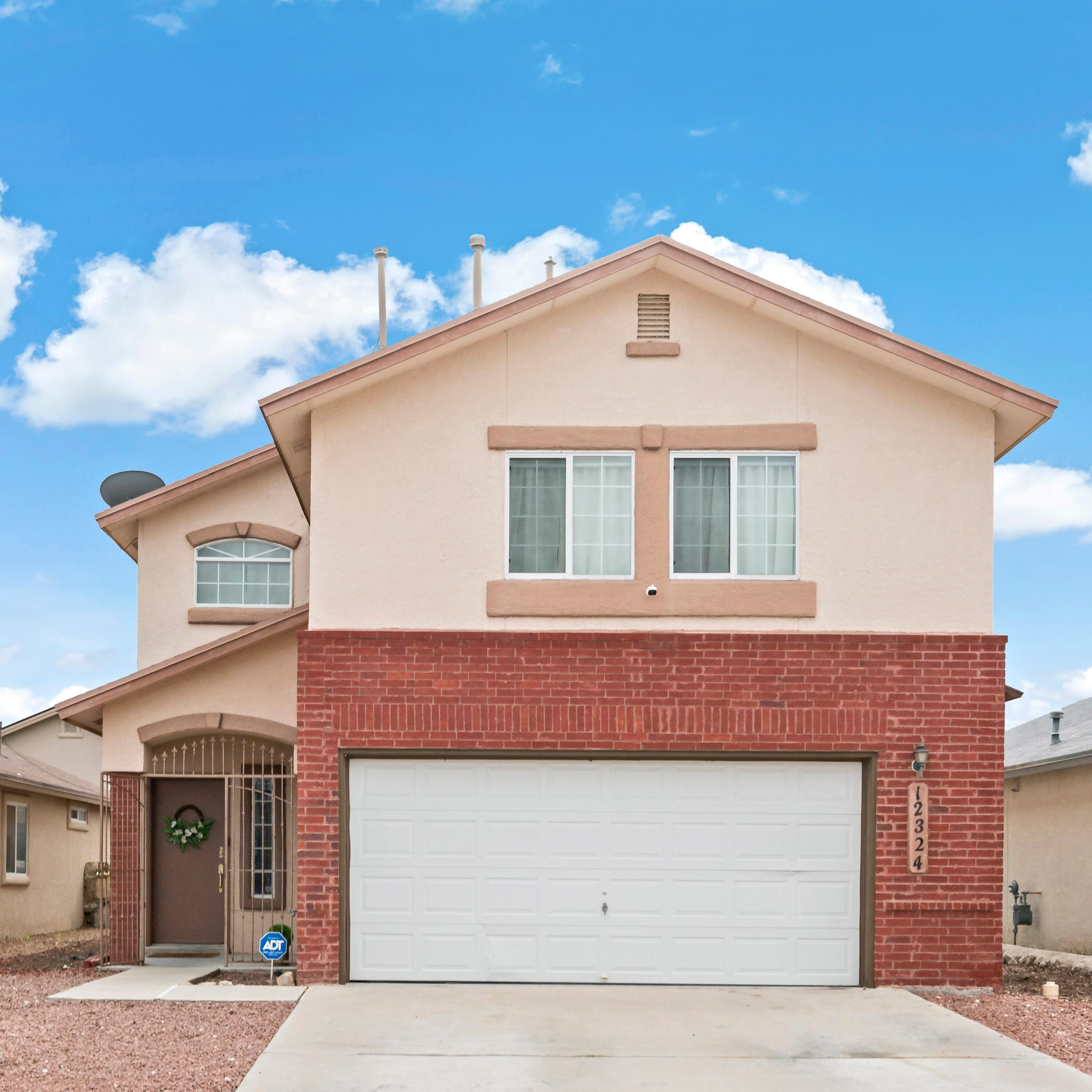 a front view of a house with a garage