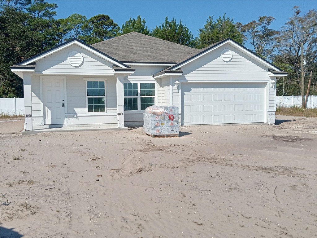 a front view of a house with a garden and entryway