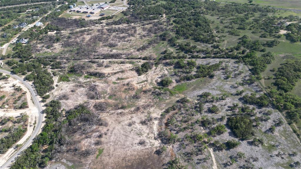 a view of a dry yard with green space