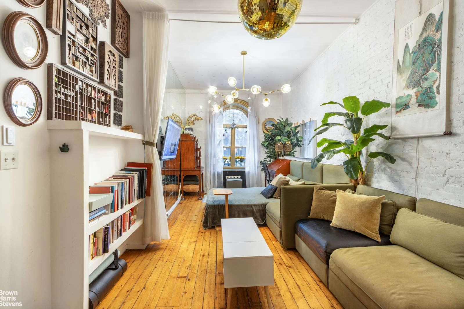 a living room with furniture a chandelier and a fireplace