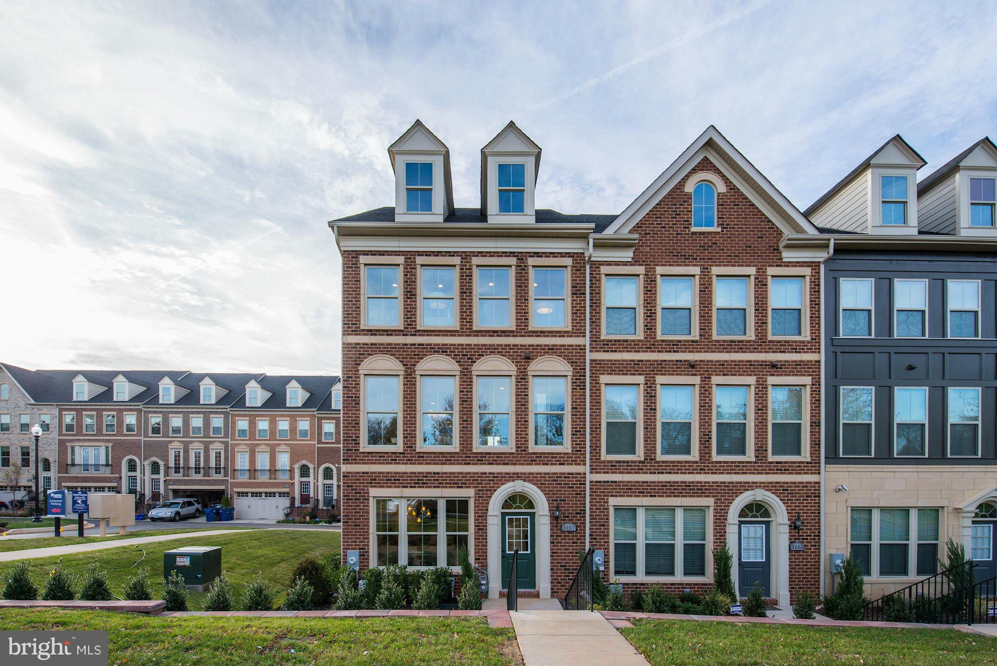 a front view of a residential apartment building with a yard