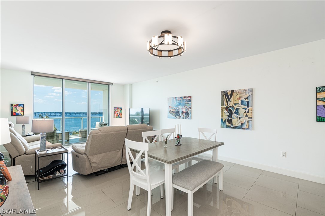 a dining room with furniture a rug and a chandelier