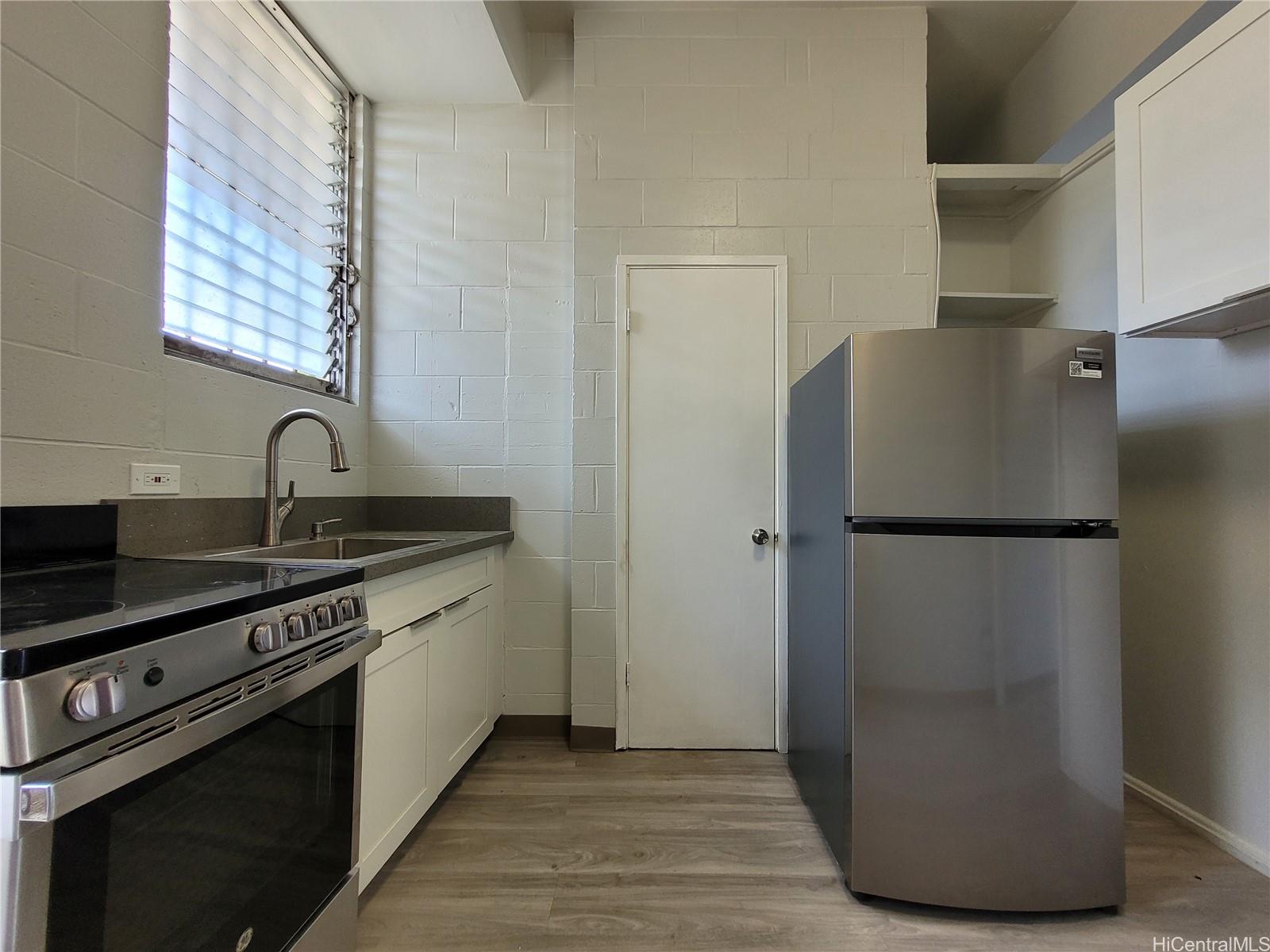 a kitchen with a refrigerator and a sink