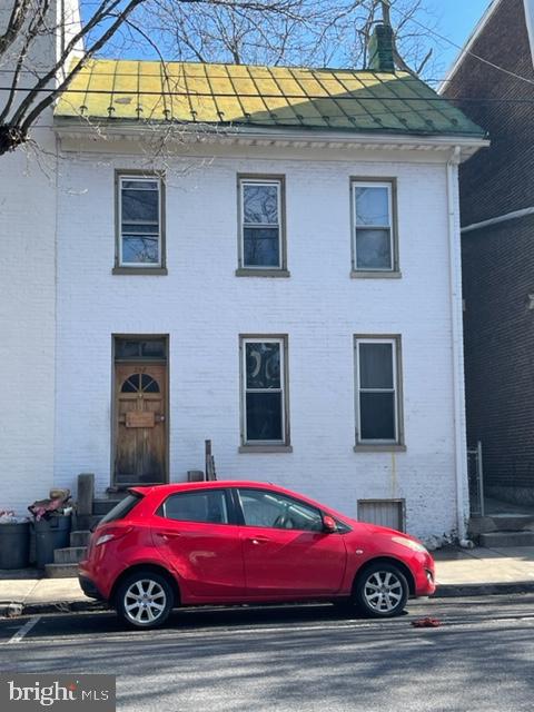 a car parked in front of a brick house