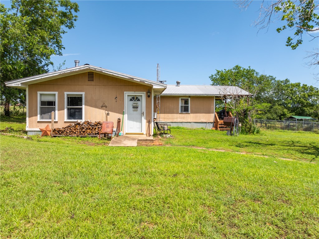 a front view of house with yard and outdoor seating