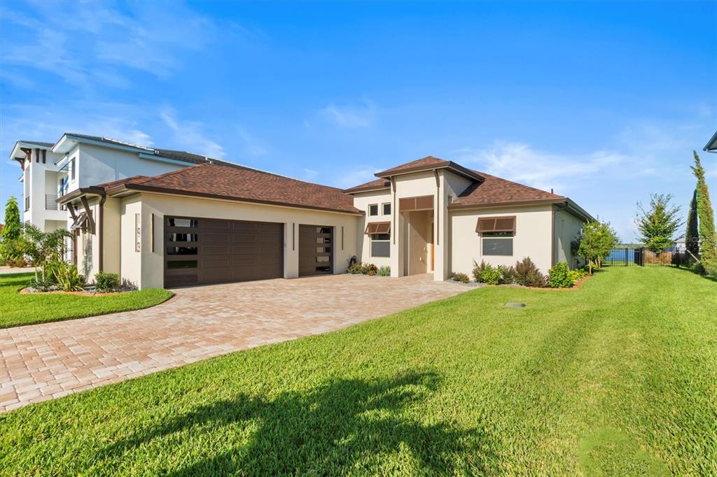 a front view of a house with a garden and yard