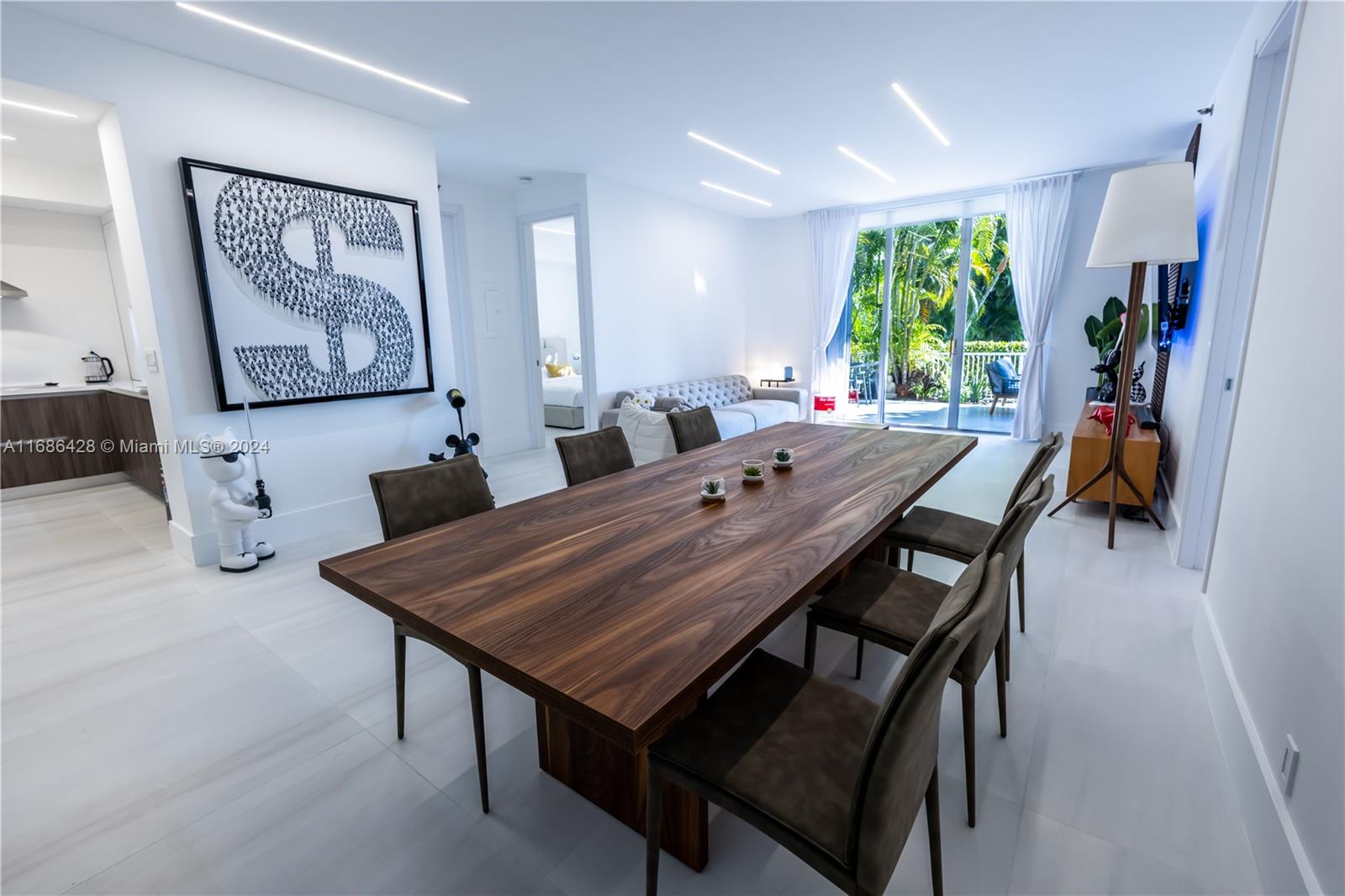 a view of a dining room with furniture and a potted plant