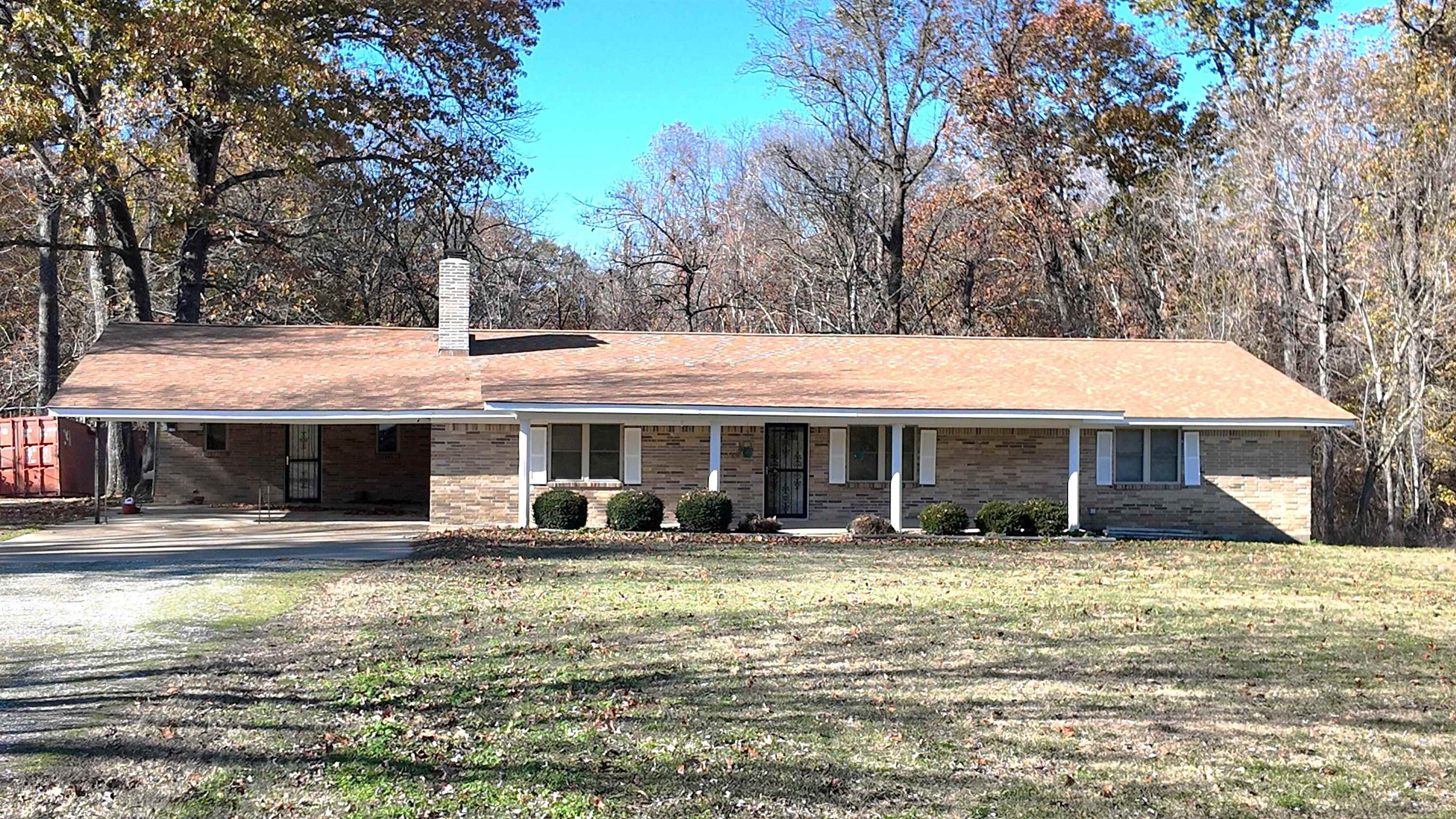 Ranch-style house featuring a front yard and a carport