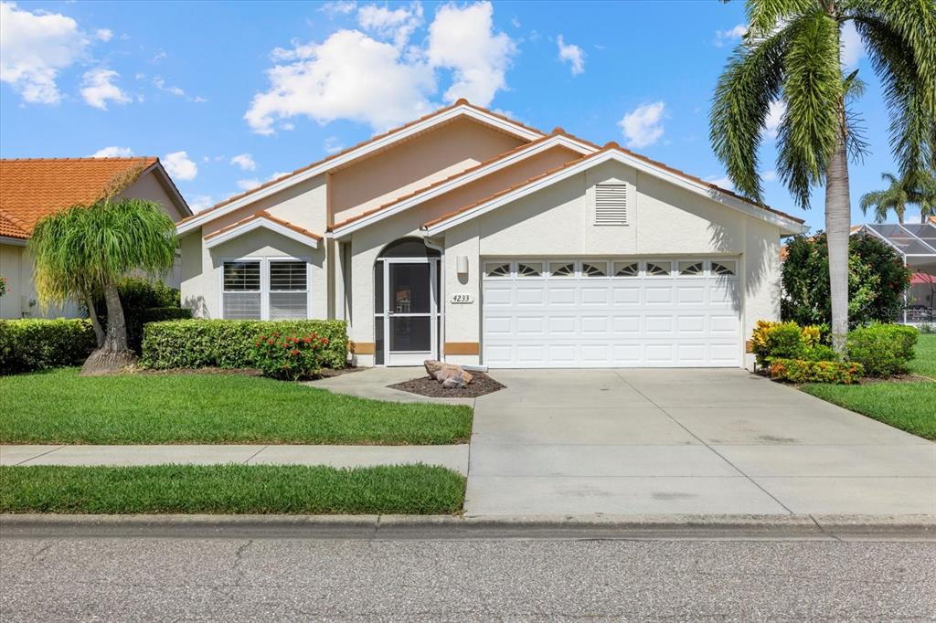 a front view of a house with a yard and garage